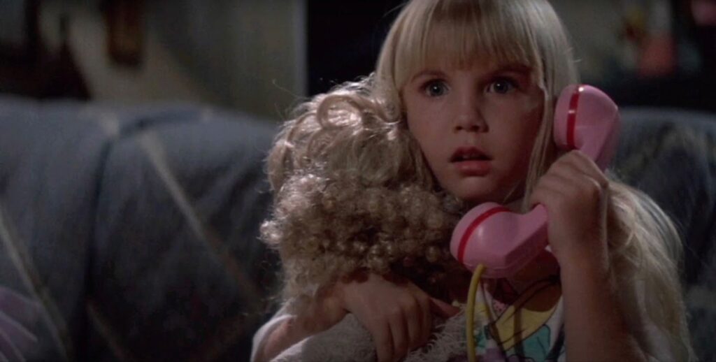 Heather O'rourke girl with a phone and a toy in her hands