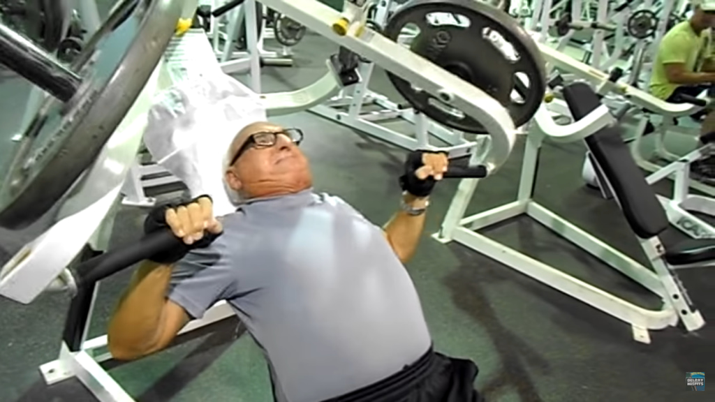 Person bench-pressing in a gym with weight equipment